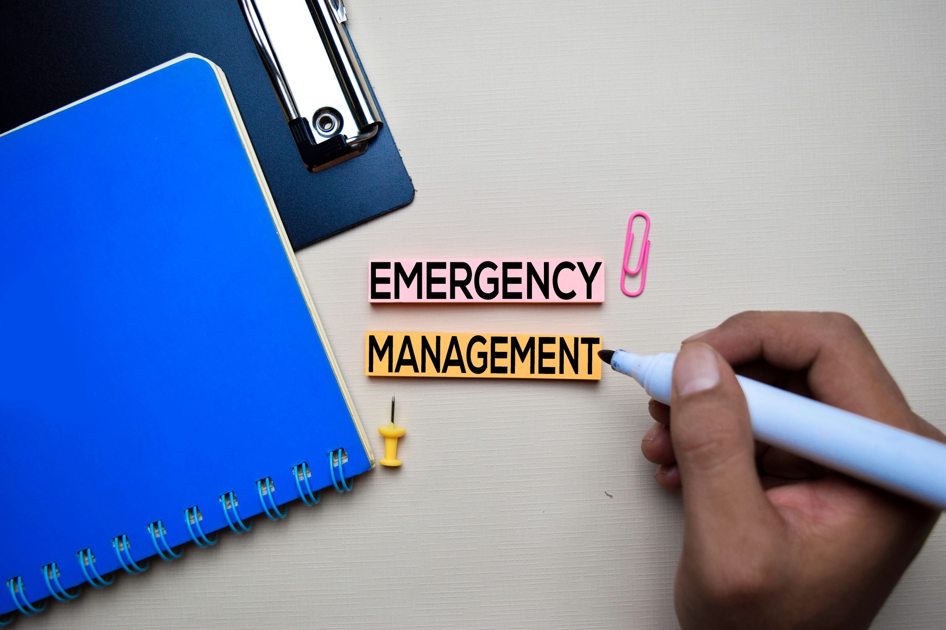Emergency Management text on sticky notes with office desk concept